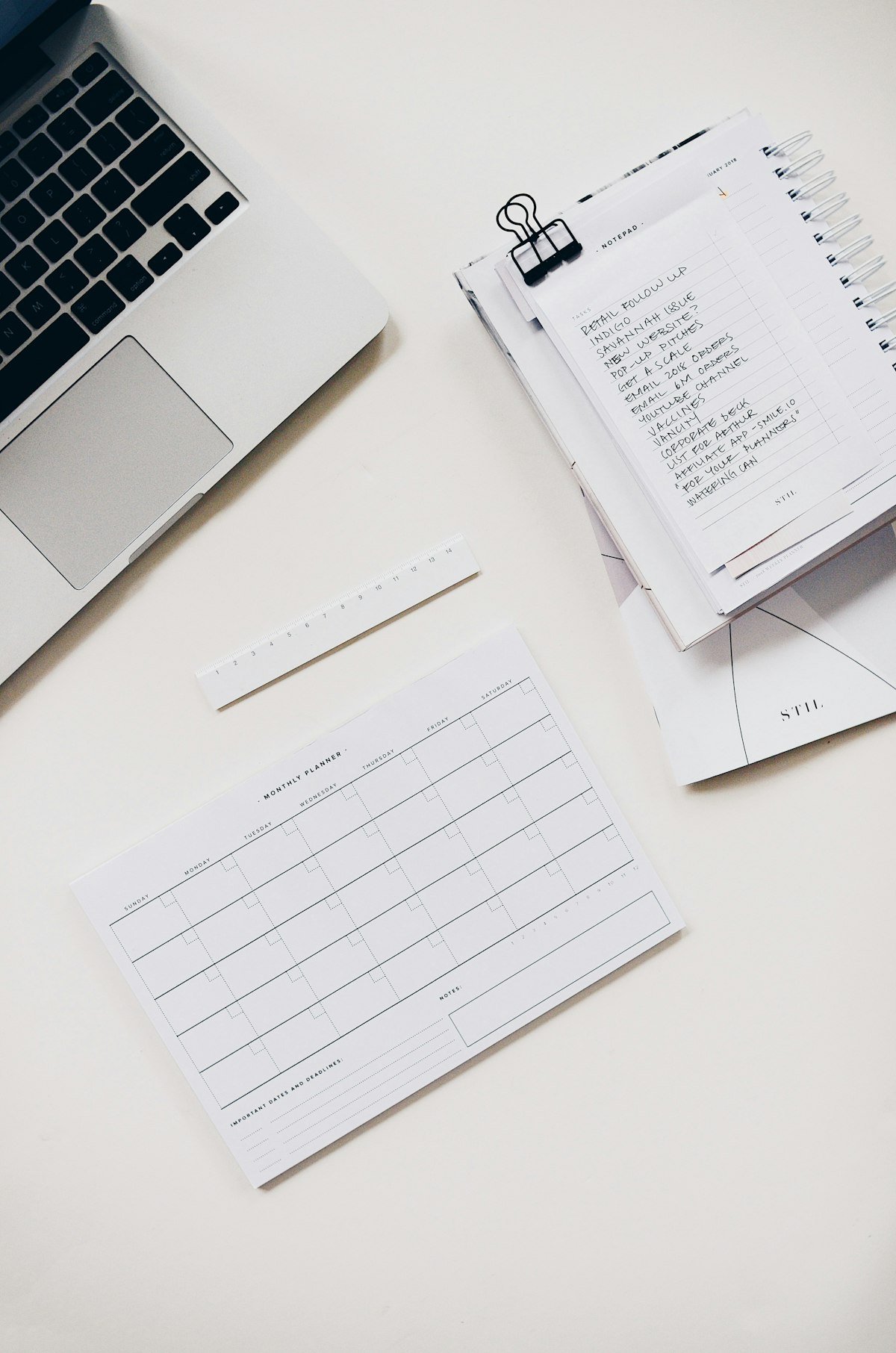 Financial planning documents and a pen laid out on a wooden desk