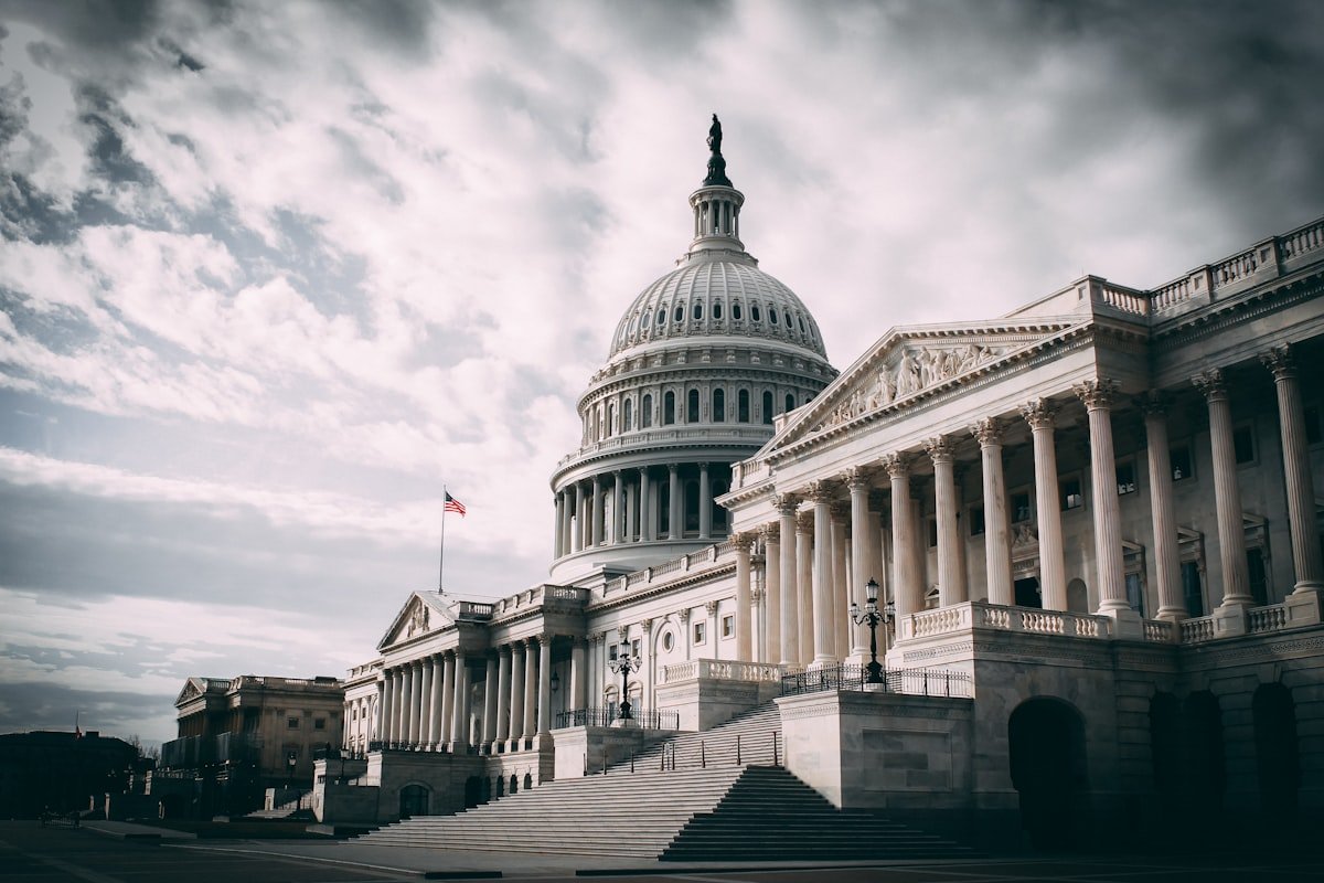 The US Capitol building under a dramatic cloudy sky